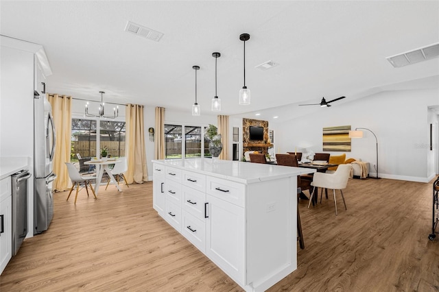 12641 98th St, Largo, FL 33773 - kitchen with visible vents, light wood-style flooring, and freestanding refrigerator