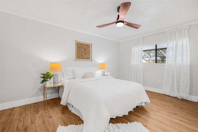 12641 98th St, Largo, FL 33773 - bedroom with crown molding, baseboards, wood finished floors, and a textured ceiling