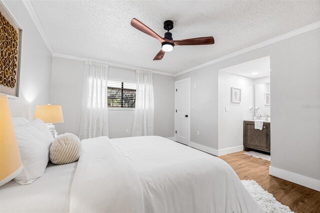 12641 98th St, Largo, FL 33773 - bedroom featuring crown molding, baseboards, wood finished floors, and a textured ceiling