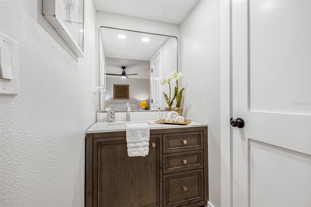 12641 98th St, Largo, FL 33773 - bathroom featuring a textured wall, vanity, and ceiling fan