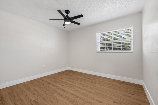 12641 98th St, Largo, FL 33773 - spare room with baseboards, a textured ceiling, and wood finished floors