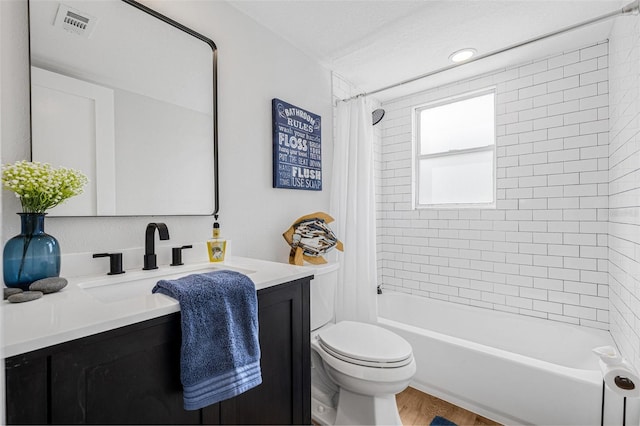 12641 98th St, Largo, FL 33773 - bathroom with vanity, toilet, visible vents, shower / bath combo with shower curtain, and wood finished floors