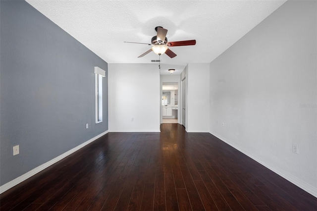 empty room featuring baseboards, a ceiling fan, and wood finished floors