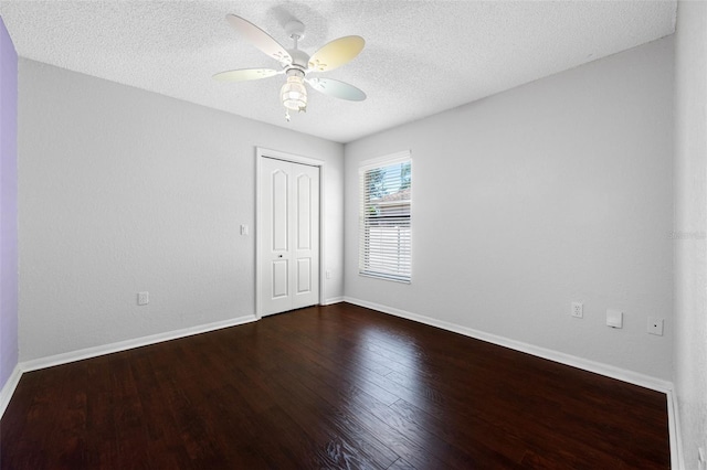 unfurnished room featuring ceiling fan, a textured ceiling, wood finished floors, and baseboards