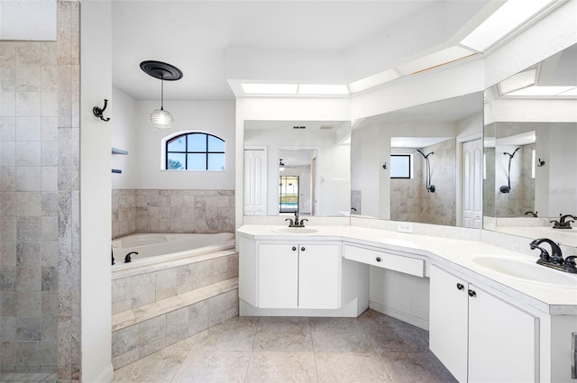bathroom with a sink, tile patterned floors, a bath, and tiled shower