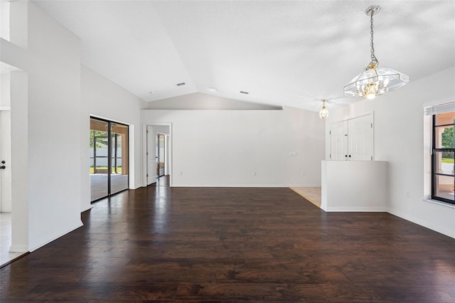unfurnished living room with a notable chandelier, baseboards, vaulted ceiling, and wood finished floors