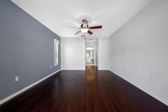 unfurnished room featuring ceiling fan, wood finished floors, baseboards, and a textured ceiling