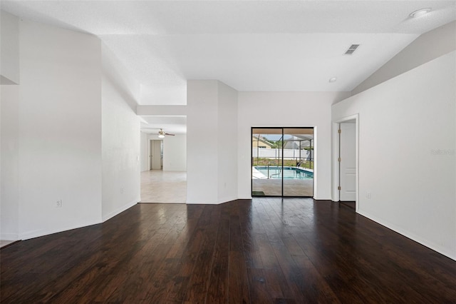 empty room with wood-type flooring, visible vents, baseboards, and ceiling fan