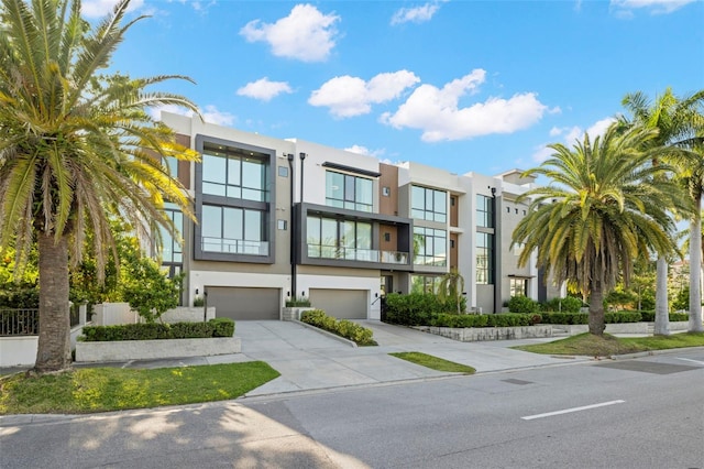 98 W Davis Blvd, Tampa, FL 33606 - view of front of home featuring concrete driveway, stucco siding, and a garage