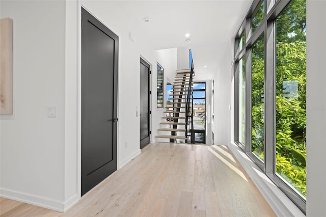 98 W Davis Blvd, Tampa, FL 33606 - corridor featuring light wood-type flooring, baseboards, plenty of natural light, and stairs
