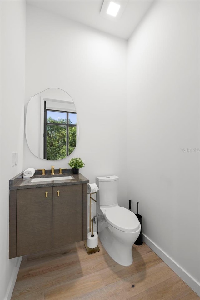 98 W Davis Blvd, Tampa, FL 33606 - half bath featuring toilet, wood finished floors, vanity, and baseboards