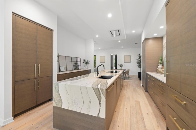 98 W Davis Blvd, Tampa, FL 33606 - kitchen with light wood-style floors, modern cabinets, recessed lighting, a large island, and a sink