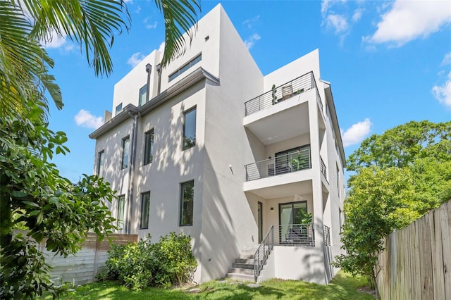 98 W Davis Blvd, Tampa, FL 33606 - back of property with fence, a balcony, and stucco siding