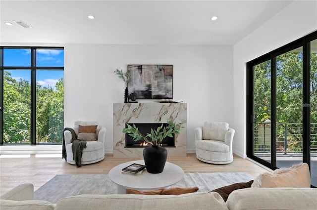 98 W Davis Blvd, Tampa, FL 33606 - living room featuring a premium fireplace, wood finished floors, visible vents, and recessed lighting