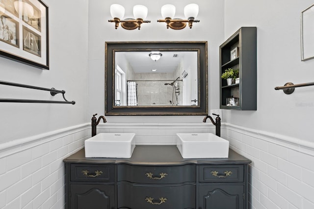 636 16th Ave NE, Saint Petersburg, FL 33704 - full bathroom with wainscoting, tile walls, and a sink