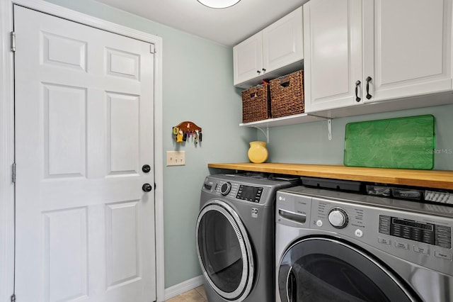 636 16th Ave NE, Saint Petersburg, FL 33704 - laundry room with baseboards, washing machine and clothes dryer, and cabinet space