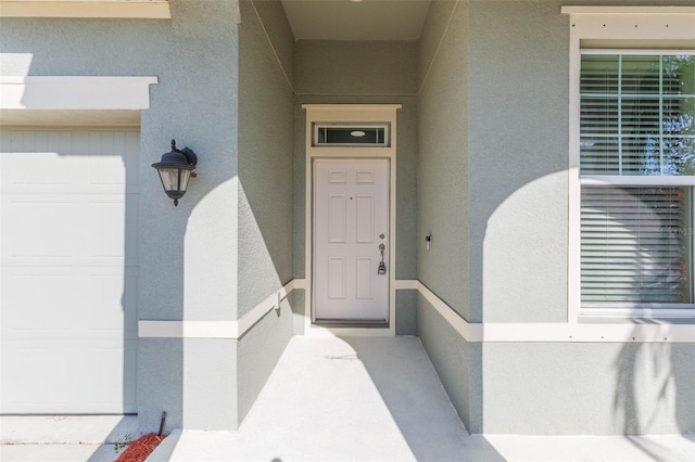 entrance to property with stucco siding