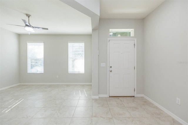 entryway with plenty of natural light, baseboards, and a ceiling fan