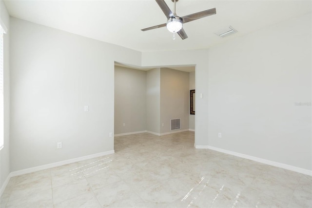 spare room featuring ceiling fan, baseboards, and visible vents