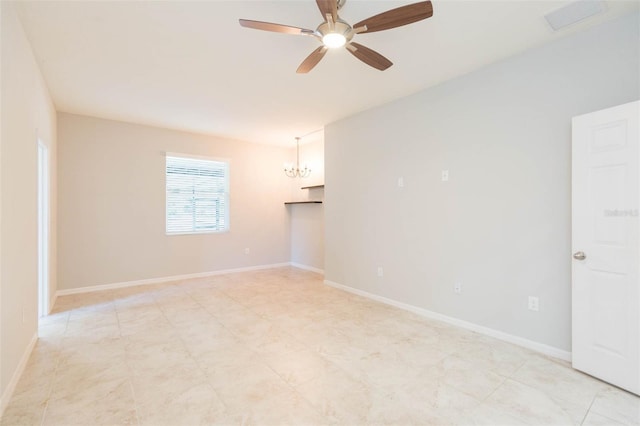 spare room featuring ceiling fan with notable chandelier, baseboards, and visible vents