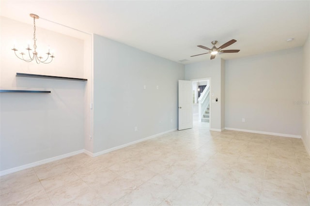 unfurnished living room with stairway, ceiling fan with notable chandelier, and baseboards