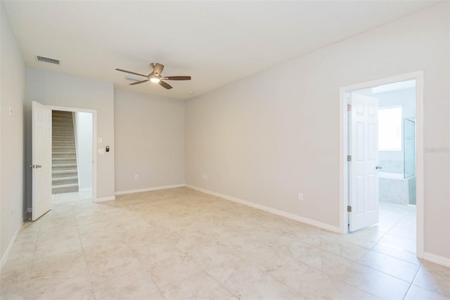 unfurnished room featuring light tile patterned floors, baseboards, a ceiling fan, and visible vents