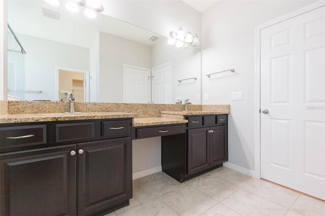 full bath featuring tile patterned floors, double vanity, a sink, and visible vents