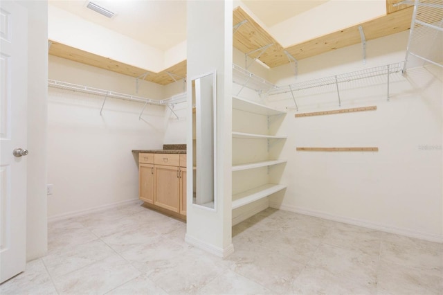 spacious closet featuring visible vents