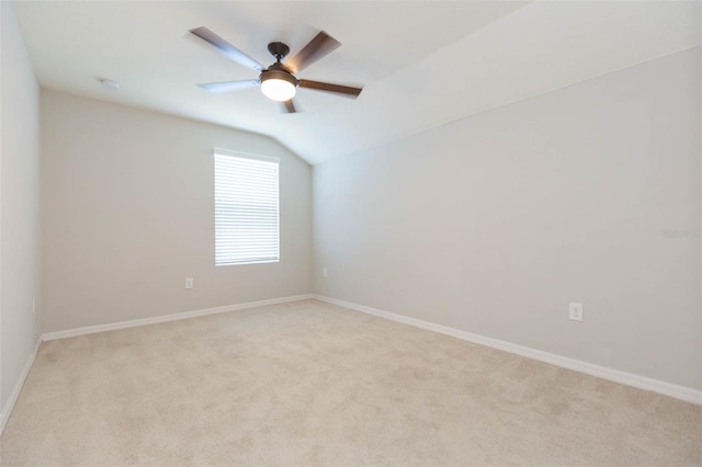 unfurnished room featuring light carpet, baseboards, a ceiling fan, and lofted ceiling