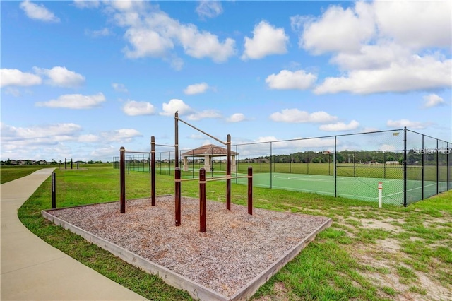 view of play area featuring fence and a lawn