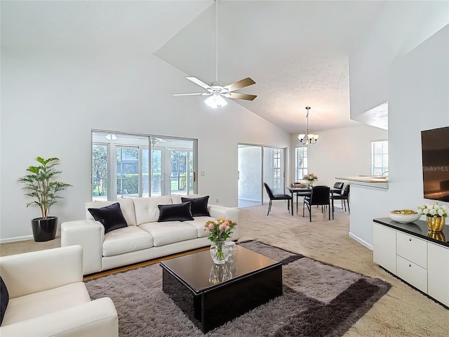 carpeted living room featuring baseboards, high vaulted ceiling, and a healthy amount of sunlight