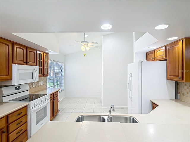 kitchen featuring white appliances, light tile patterned flooring, ceiling fan, decorative backsplash, and a sink