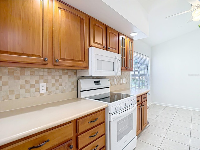 kitchen with white appliances, light countertops, light tile patterned flooring, brown cabinetry, and decorative backsplash