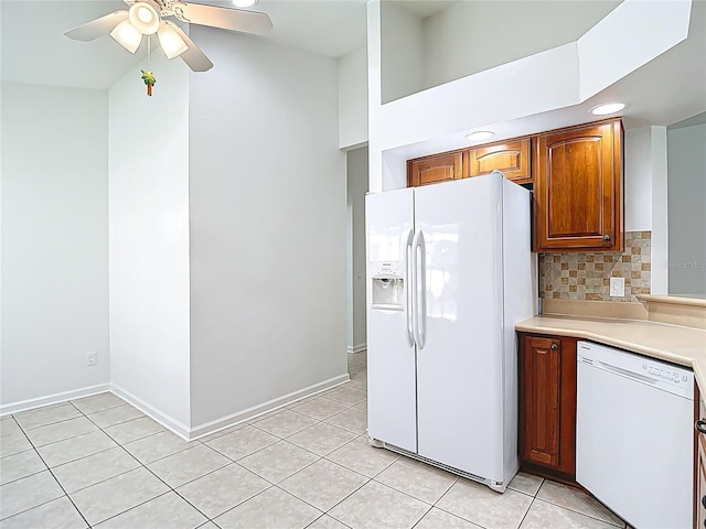 kitchen featuring recessed lighting, white appliances, light tile patterned floors, light countertops, and backsplash