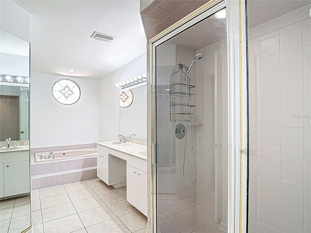 bathroom with a shower stall, two vanities, a garden tub, and a sink