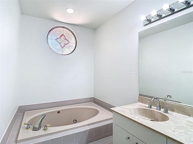 bathroom with a jetted tub and vanity