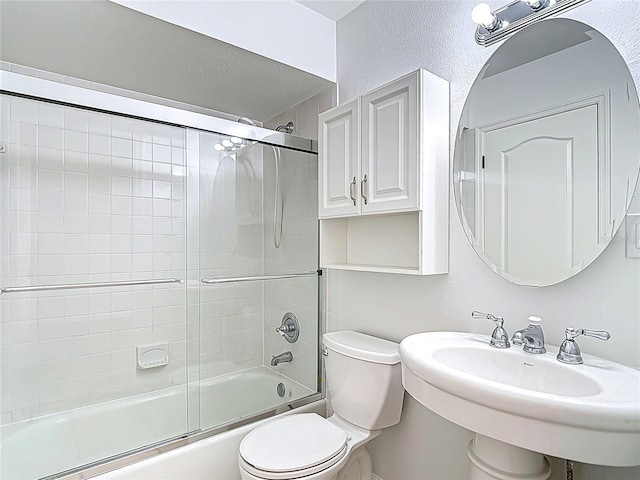 full bathroom with enclosed tub / shower combo, a sink, and toilet