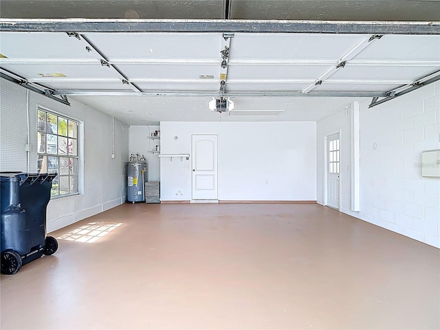 garage featuring electric water heater and a garage door opener