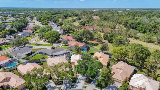 aerial view featuring a wooded view and a residential view