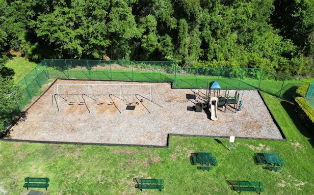 view of home's community with fence, a lawn, and playground community