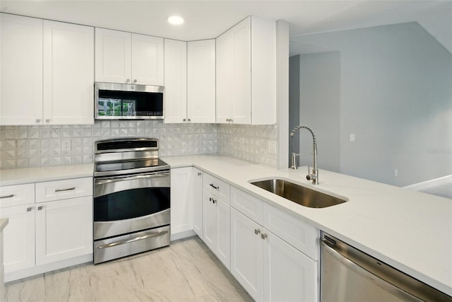 6994 Country Lakes Cir, Sarasota, FL 34243 - kitchen with appliances with stainless steel finishes, light countertops, white cabinets, and recessed lighting