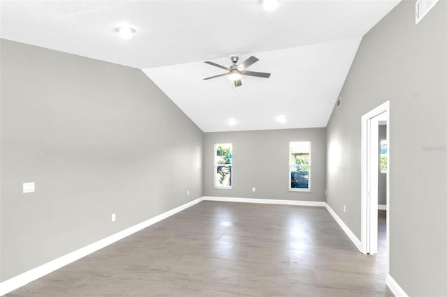 6994 Country Lakes Cir, Sarasota, FL 34243 - spare room with ceiling fan, wood finished floors, and high vaulted ceiling