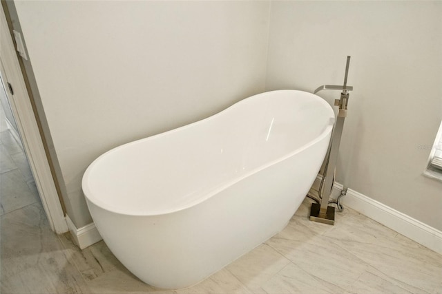 6994 Country Lakes Cir, Sarasota, FL 34243 - bathroom with a soaking tub and marble look tiles