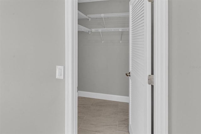 6994 Country Lakes Cir, Sarasota, FL 34243 - spacious closet featuring marble look tiles
