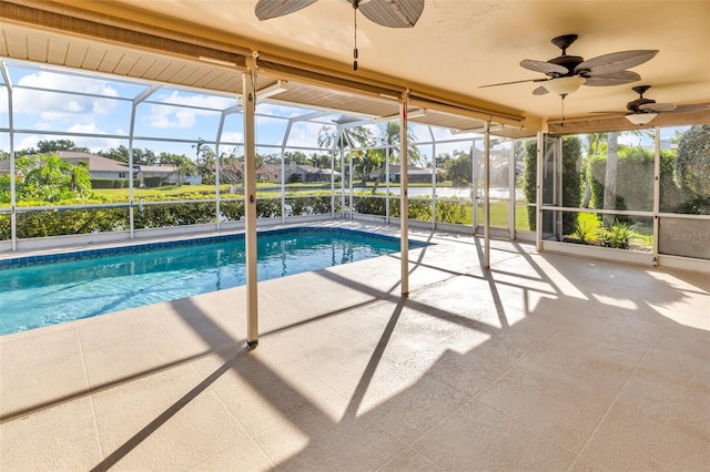 6994 Country Lakes Cir, Sarasota, FL 34243 - outdoor pool featuring ceiling fan, a patio area, glass enclosure, and a residential view