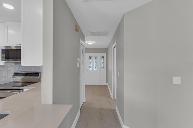 6994 Country Lakes Cir, Sarasota, FL 34243 - corridor with baseboards and attic access