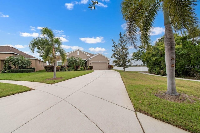 view of front of house featuring concrete driveway, a front yard, and a garage