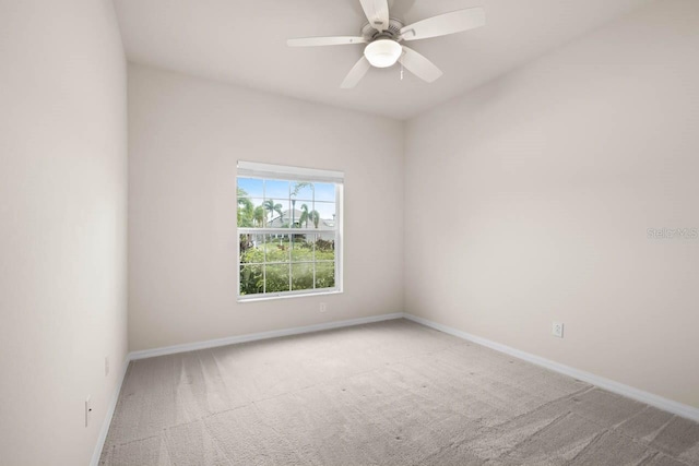 carpeted empty room featuring baseboards and a ceiling fan
