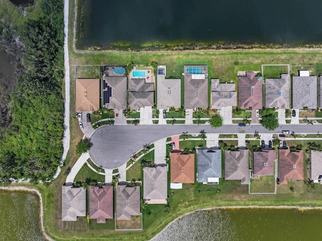 birds eye view of property featuring a water view and a residential view