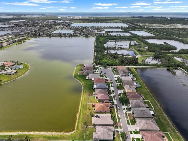 bird's eye view featuring a water view and a residential view